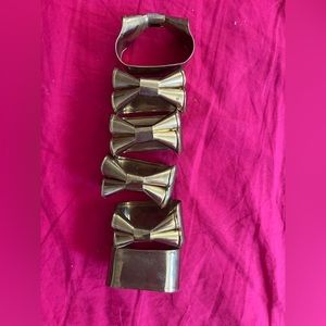 Set of six brass bow vintage napkin rings